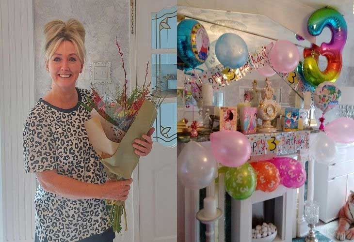 Foster carer Paula holding a bouquet of flowers next to child's birthday cards and balloon's  