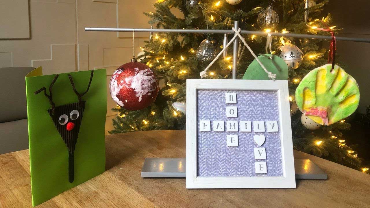 Christmas display of card made by child and picture frame with words 'Home, family, love'