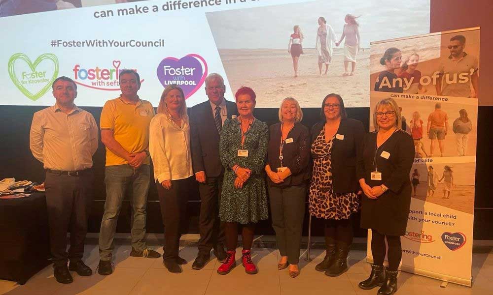 Members of Liverpool fostering team in front of fostering presentation