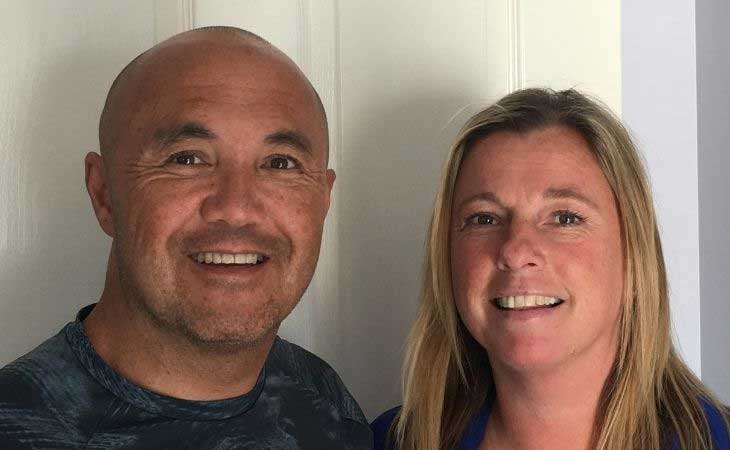 Foster carers Tony and Vicky side-by-side and smiling