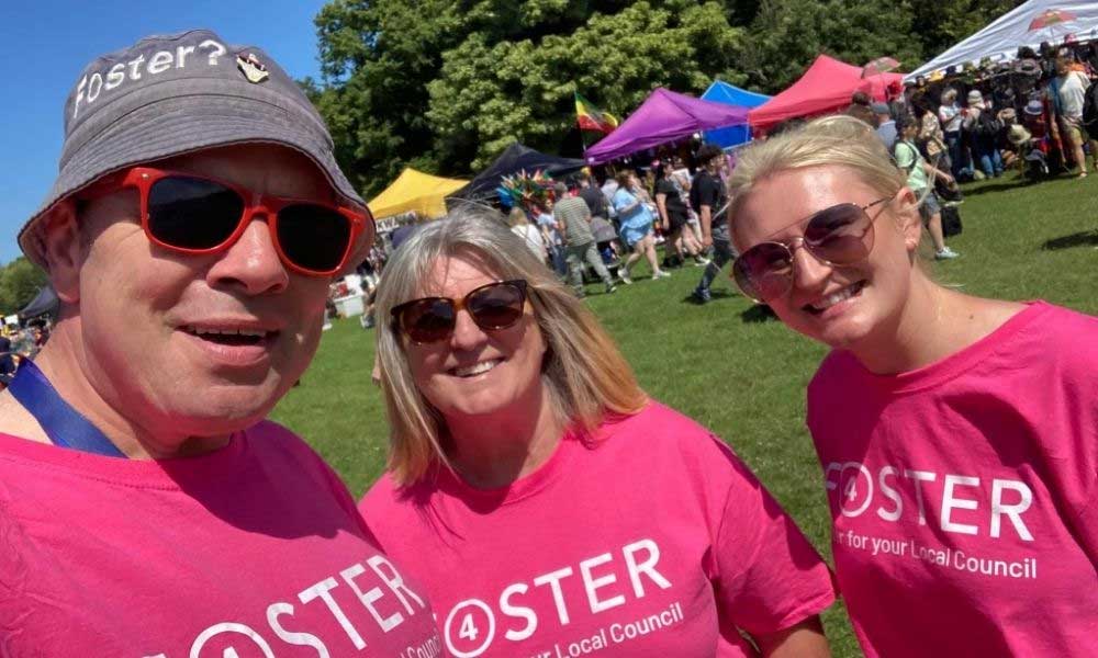 Members of the Fostering Liverpool team wearing matching foster 4 t-shirts at an outdoor event