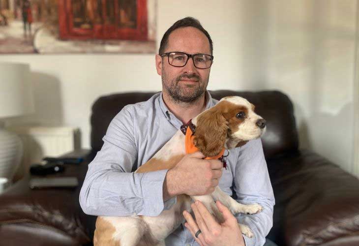 Foster carer holding dog on lap