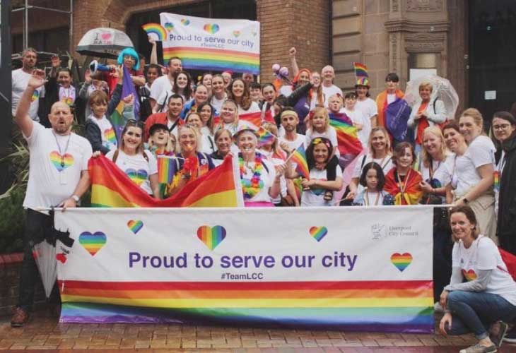 LGBTQ banners being held by Liverpool Council staff and Fostering team staff