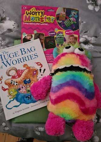 A plush monster toy alongside two books - The Huge Bag of Worries and Worry Monster