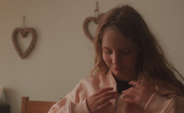 Young girl fastening up her jacket