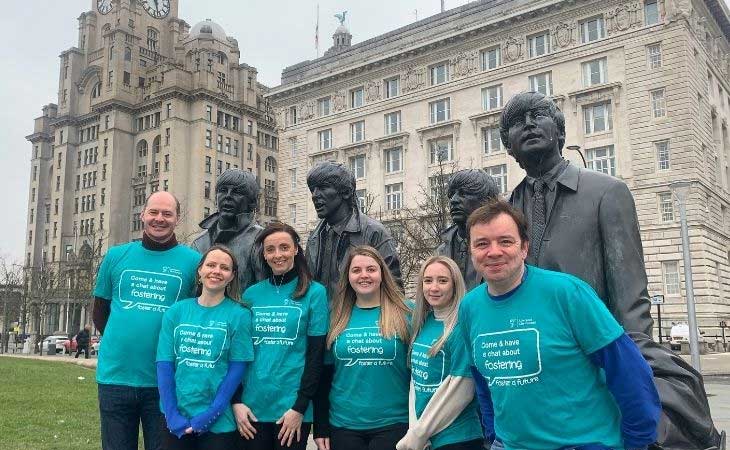 Liverpool Fostering team standing in front of Beatles statue at Pier Head, Liverpool