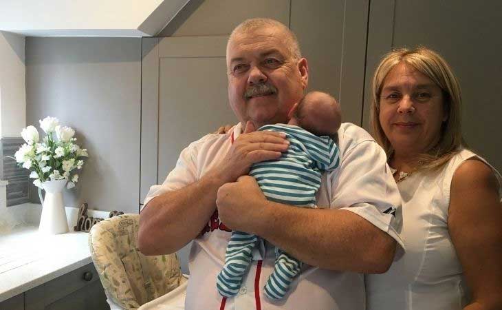 Foster carers holding newborn baby